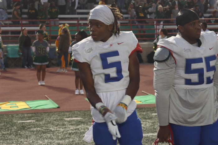 Dakoda Fields pulls on Oregon gloves ahead of a game against Long Beach Poly.